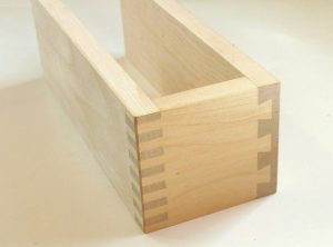 Half-built wooden pine box with dovetail joints